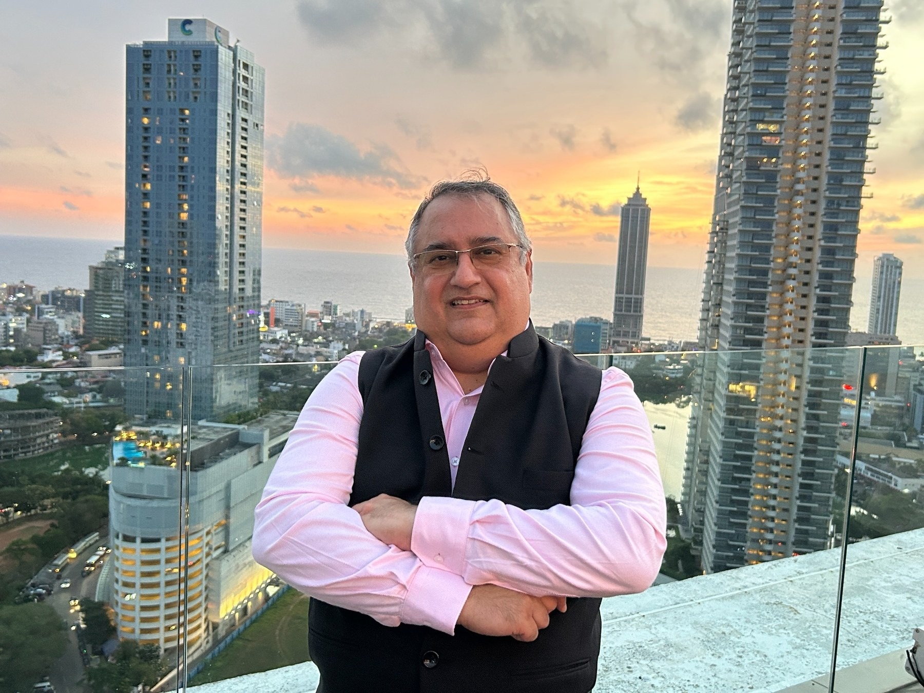 Vineet Trakroo on a balcony above the city skyline