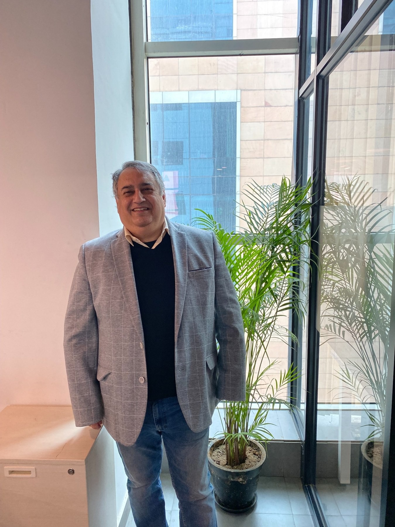Vineet Trakroo at the window of the Evolution Strategy Advisors office