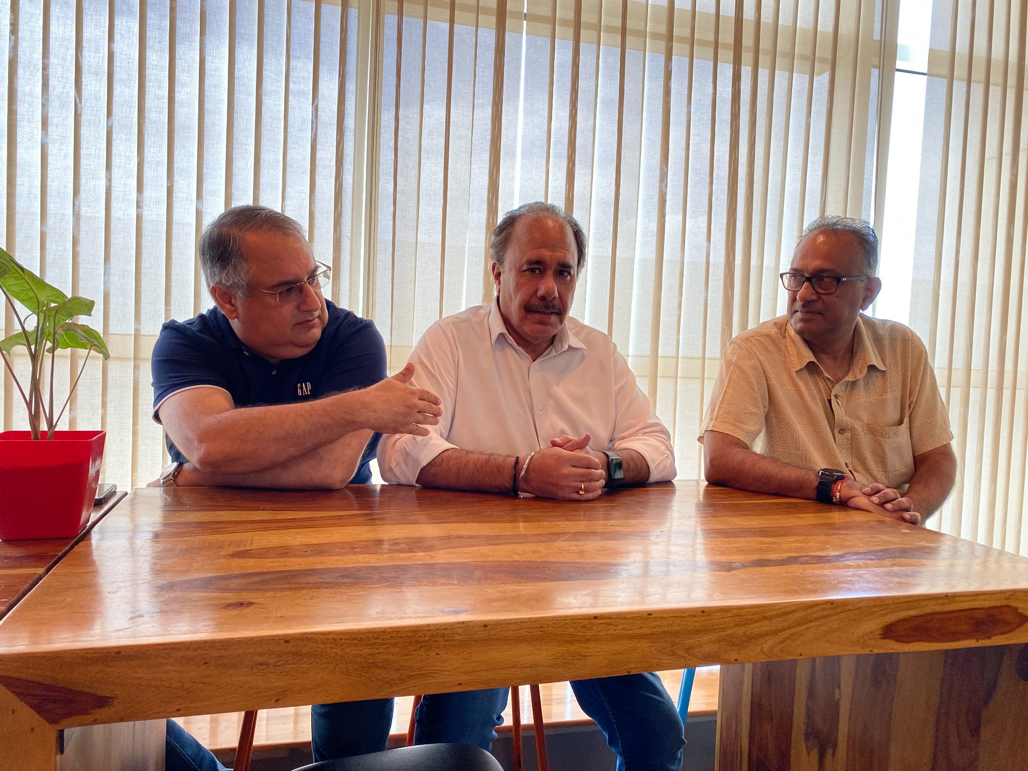 Vineet Trakroo in conversation with two colleagues at the advisory table